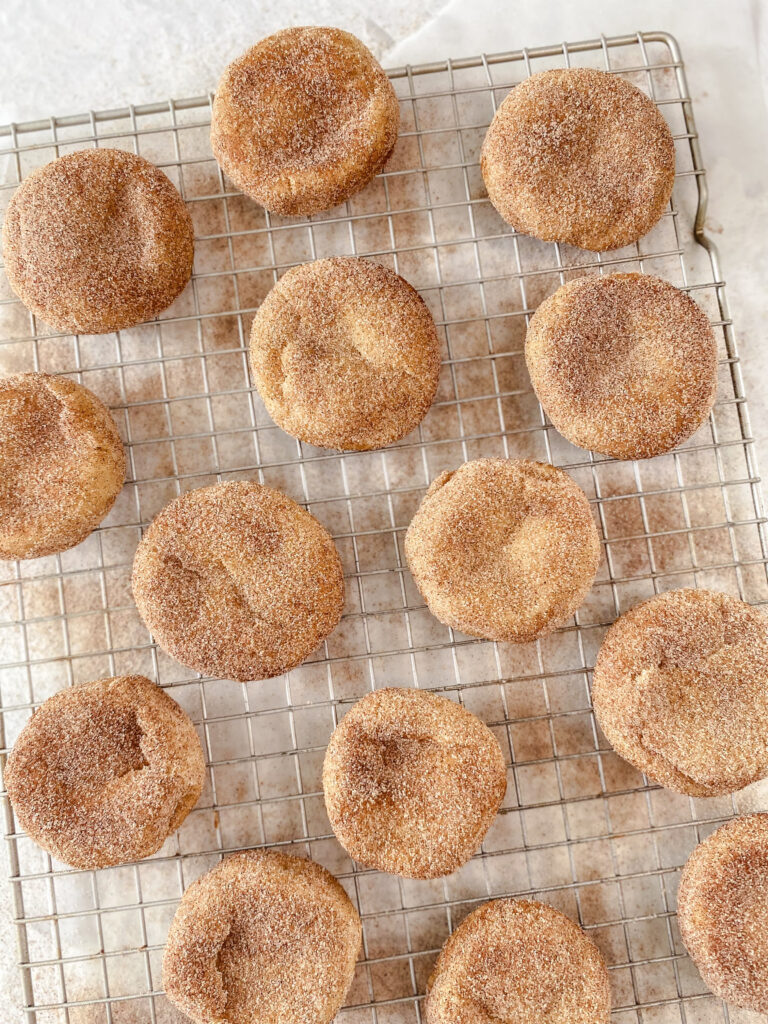 Cinnamon Snickerdoodle Cookies cooling on a wire rack.