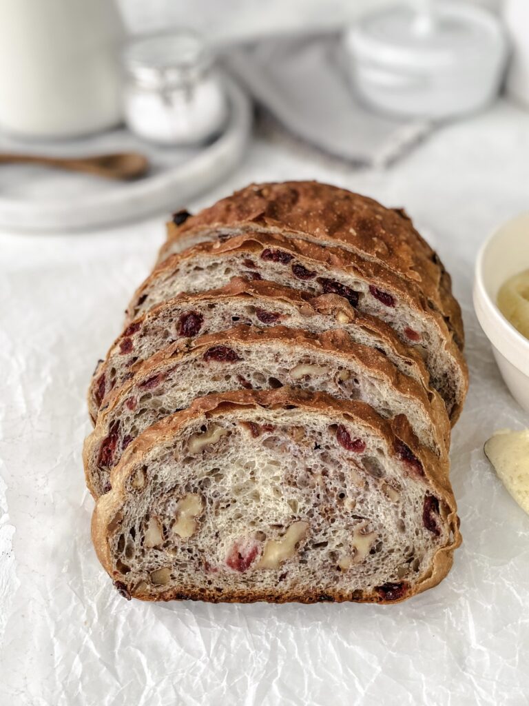 A sliced loaf of cranberry walnut bread.