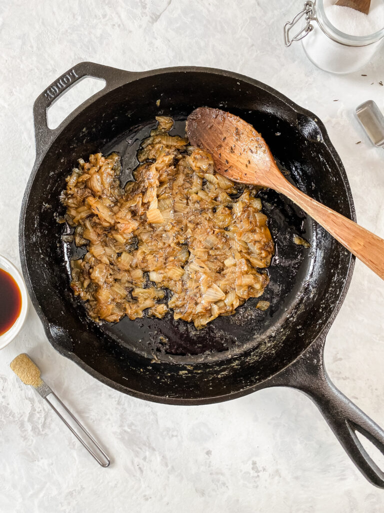 Caramelized onions in a cast-iron skillet.