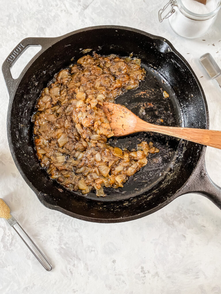 Caramelized onions in a cast-iron skillet.