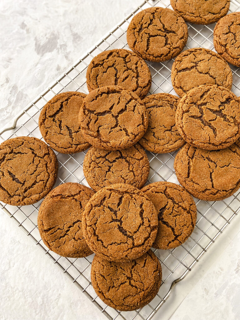 Ginger molasses cookies on a wire cooling rack.