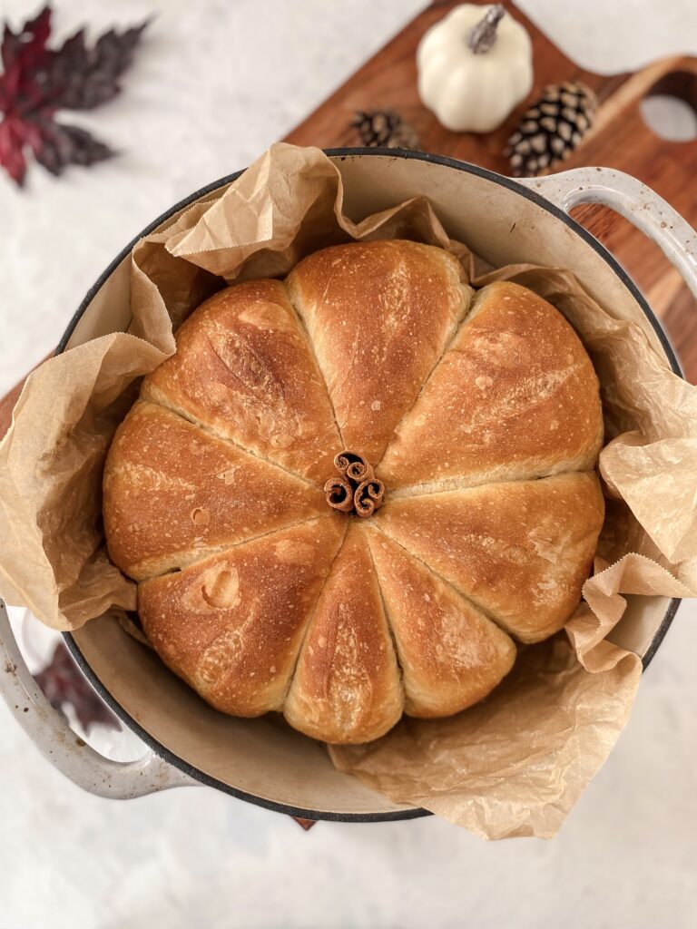 Pumpkin-Shaped Bread in a cast-iron crockpot with a cinnamon stick stem.