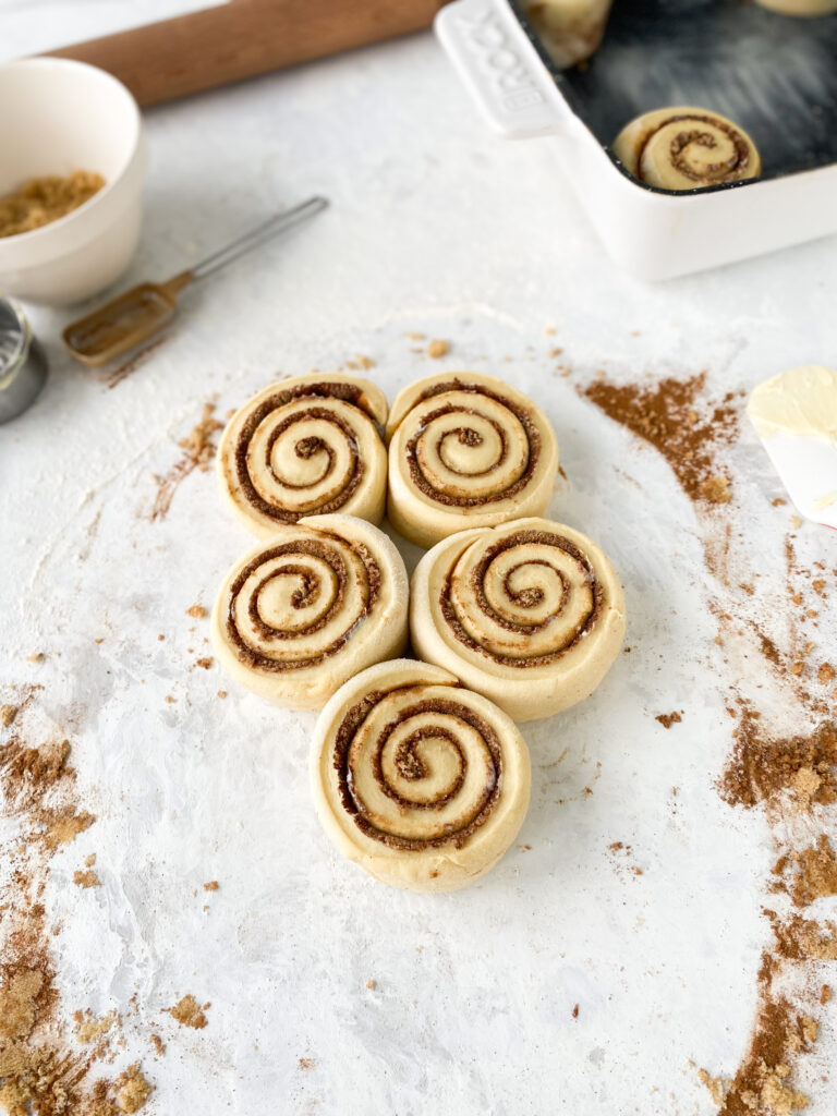 Enriched bread dough swirled with cinnamon sugar filling and cut into buns.