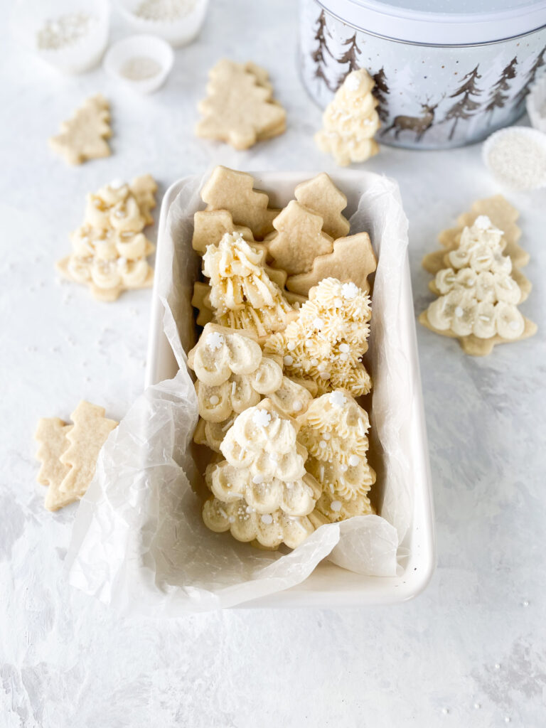 Buttercream frosted sugar cookies displayed in a loaf pan.