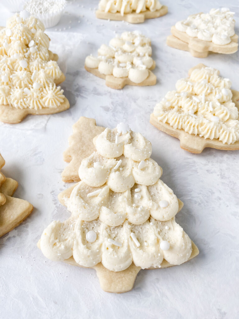 Cut out sugar cookie trees decorated with buttercream icing.