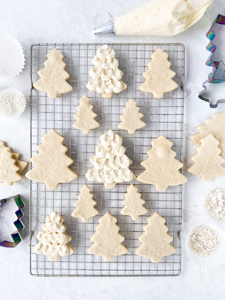 Cut out sugar cookie trees decorated with buttercream icing.