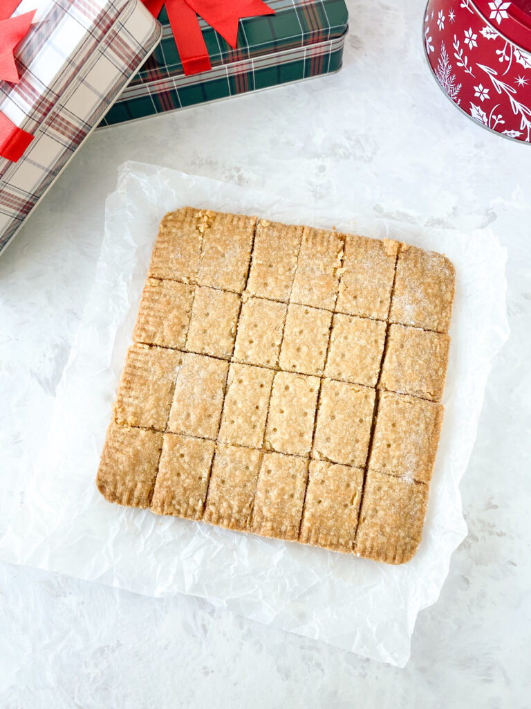 Scottish shortbread cut into squares on a white countertop.