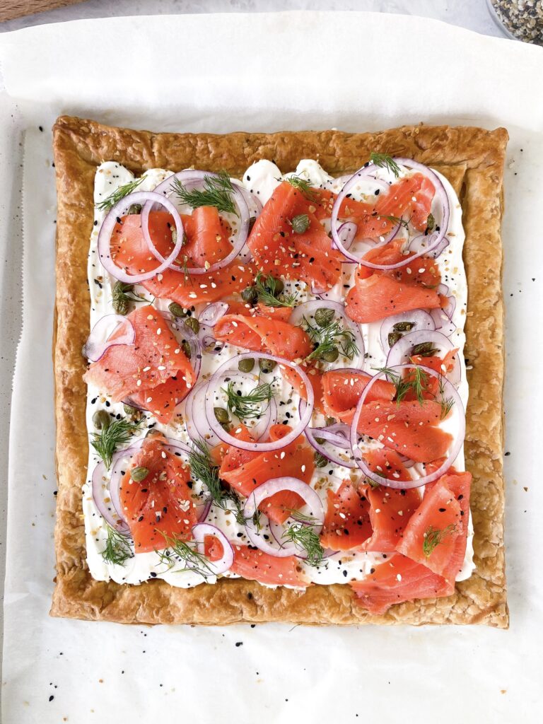 Smoked salmon tart on puff pastry topped with everything bagel seasoning.