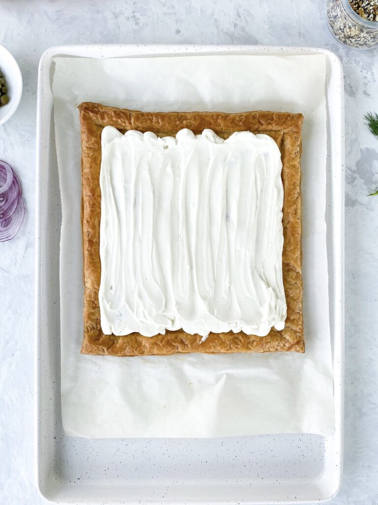 Whipped cream cheese spread over baked puff pastry tart.