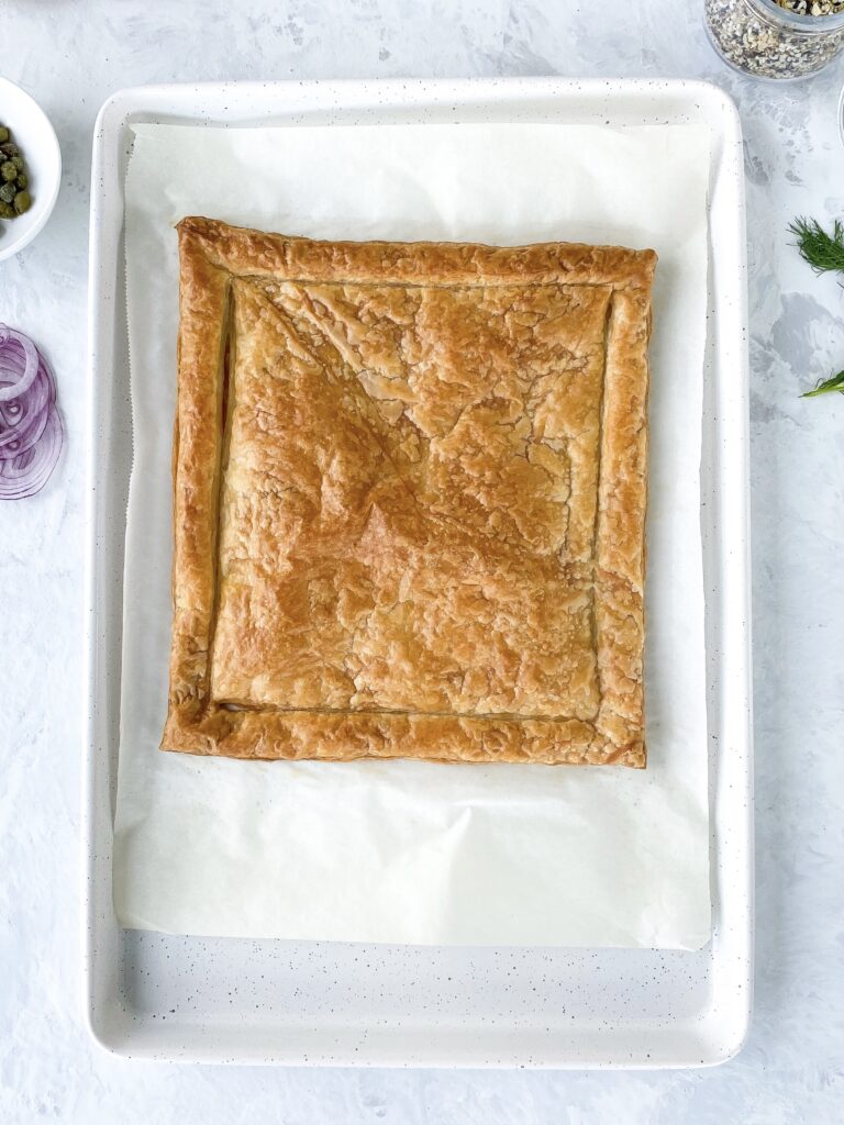 Baked puff pastry on a parchment-lined baking sheet.