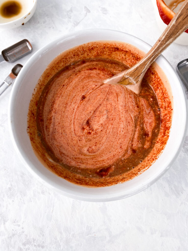 French fry sauce being stirred together in a bowl.