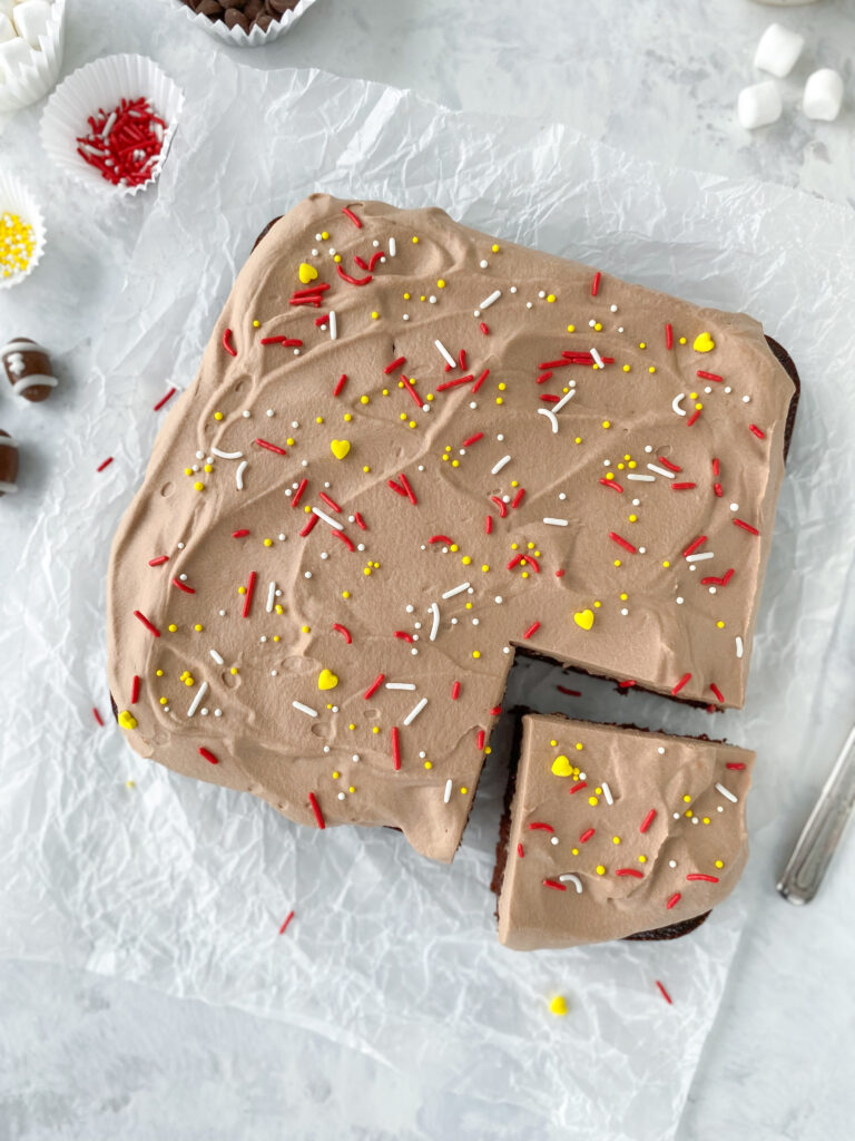 Chocolate mousse cake decorated with red, white, and yellow sprinkles.