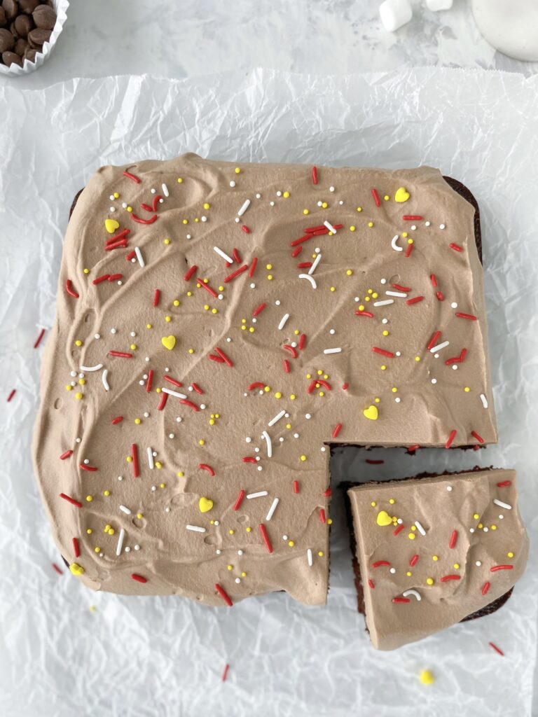 Chocolate mousse cake decorated with red, white, and yellow sprinkles.