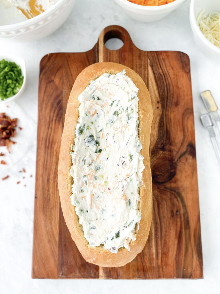 A French bread bowl stuffed with Jalapeño Popper Dip.