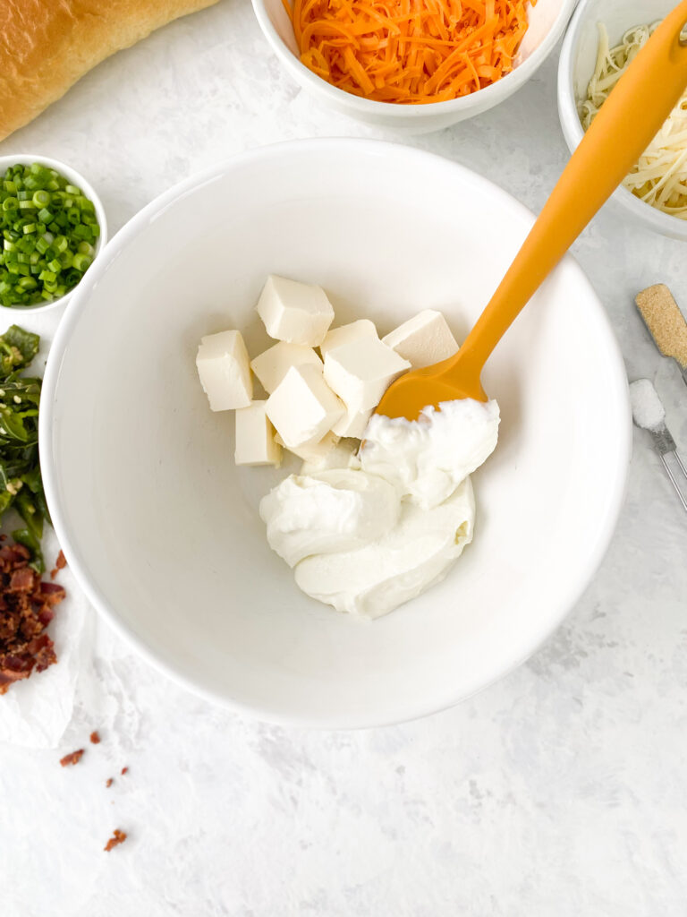 Cream cheese and Greek yogurt in a large white bowl