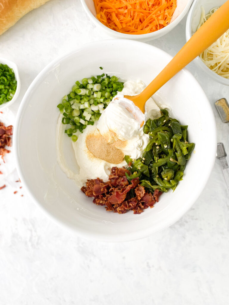 Jalapeno Popper Dip ingredients in a large bowl