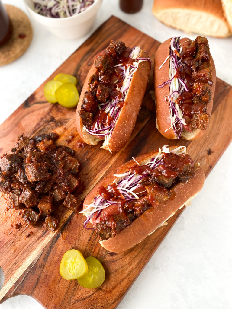 Beef hot dogs topped with brisket burnt ends, coleslaw, and sweet Kansas City barbecue sauce.