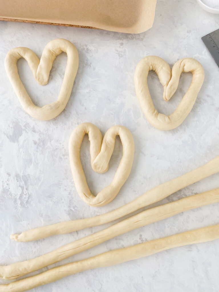 Pretzel dough shaped into hearts and ropes.