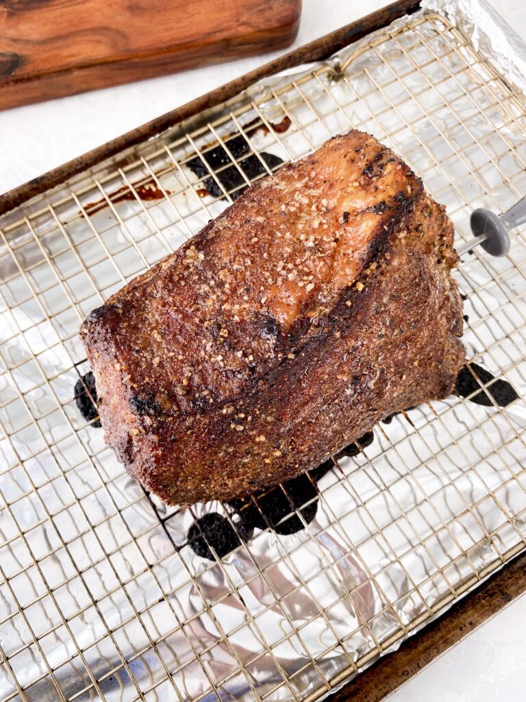 Oven-roasted roast beef, cooling on a wire rack.