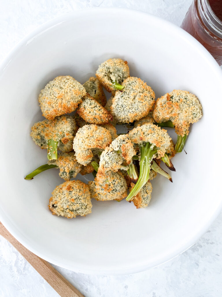 Panko-breaded broccoli in a large white bowl.