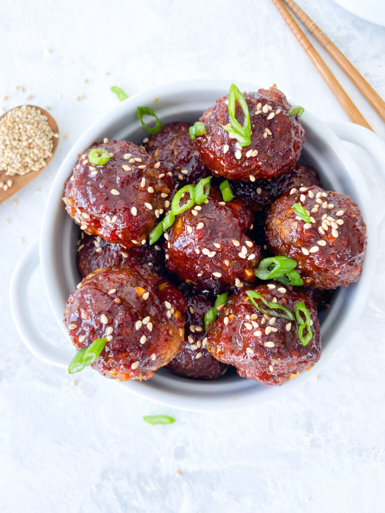 Gochujang meatballs sprinkled with green onions and sesame seeds.