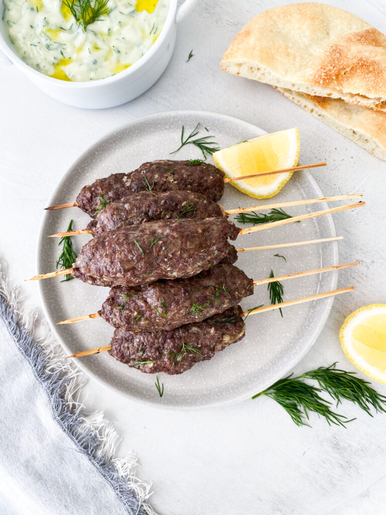 Ground beef kebabs with tzatziki and pita bread.