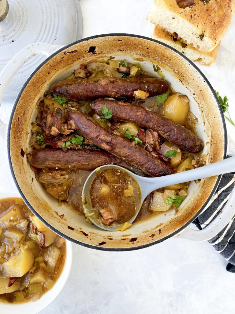 Irish sausage and potato stew (aka Dublin Coddle) being served with a ladle.