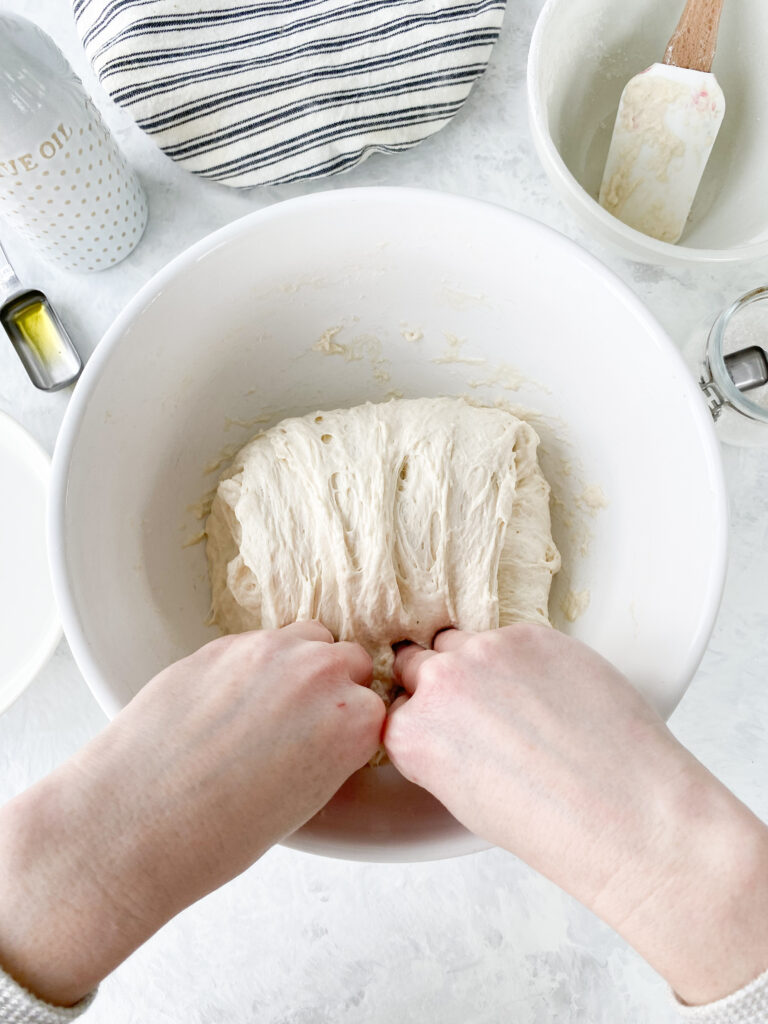 Folding dough over itself during the process of stretching and folding no knead bread