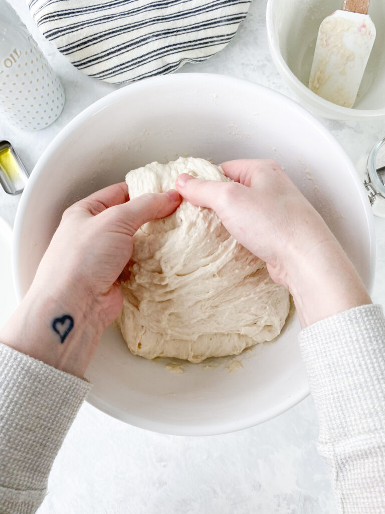 Stretching dough during the process of stretching and folding no knead bread