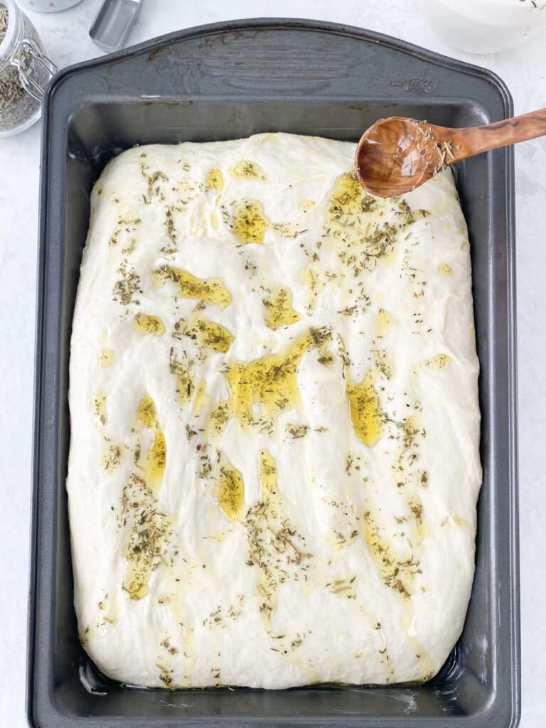 Focaccia dough drizzled with herb oil