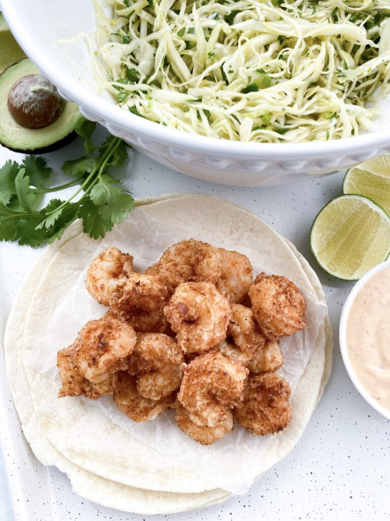 Shrimp soaked in buttermilk, breaded, and fried for Baja tacos with shredded cabbage slaw.