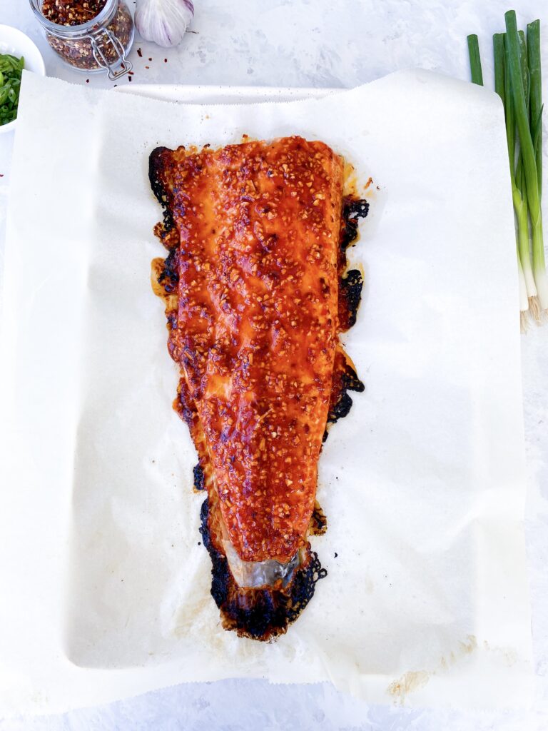 Lazy Girl Spicy Salmon Bake: a whole side of salmon coated in spicy firecracker sauce and perfectly baked.