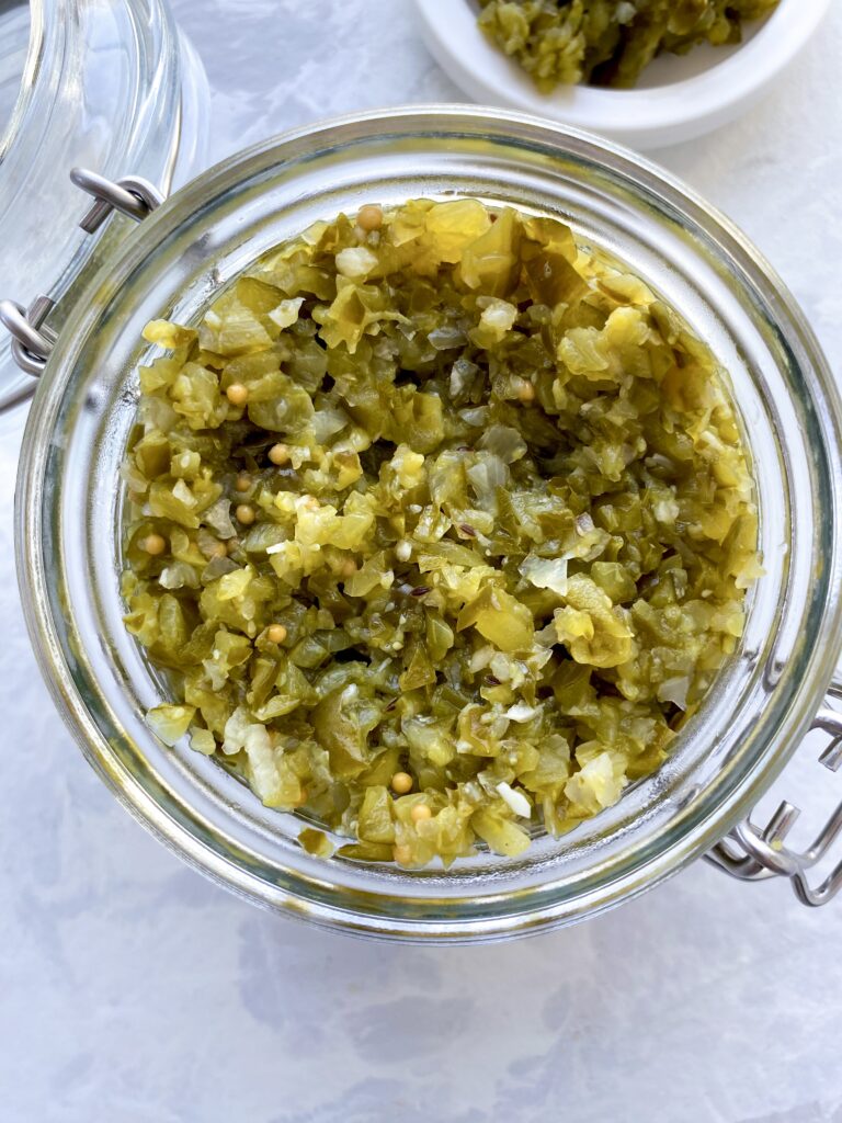 Homemade pickle relish in a glass jar with a flip-top lid