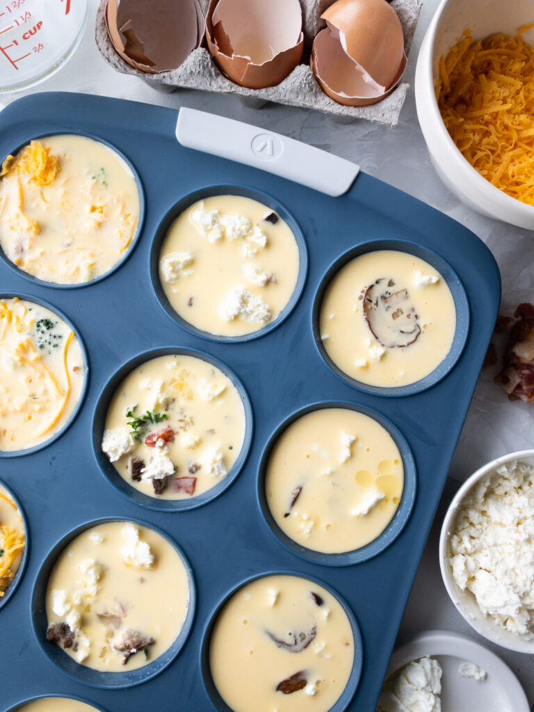 A close up of homemade muffin tin egg bites, before baking.