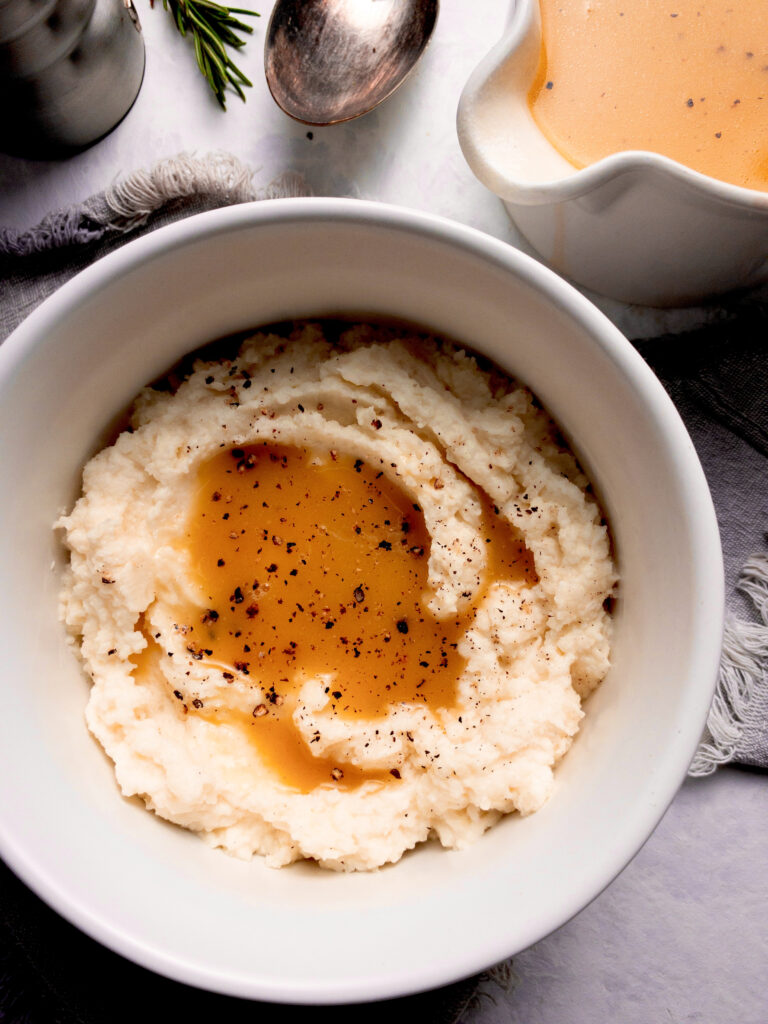 Easy gluten-free keto gravy served over creamy mashed cauliflower.