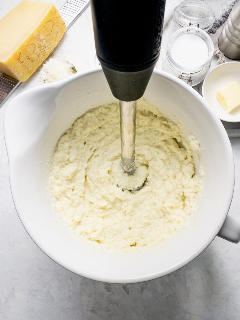 Creamy mashed cauliflower blended with cream cheese, butter, parmesan, and salt. For a buttery smooth holiday side dish.
