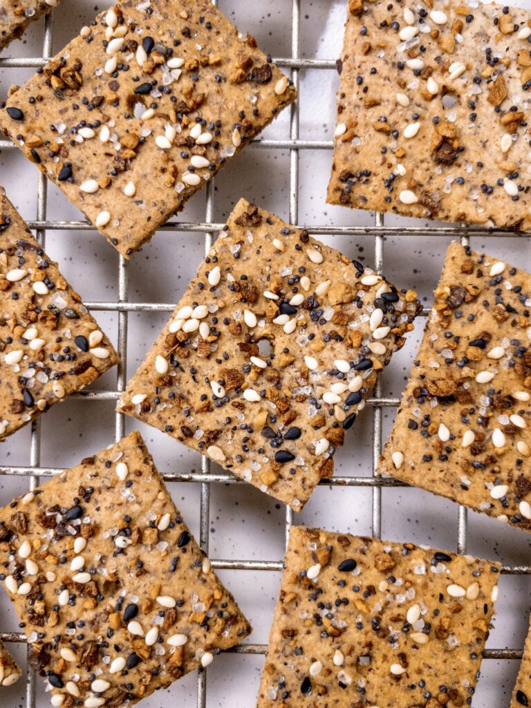Homemade gluten-free everything bagel crackers on a wire rack.