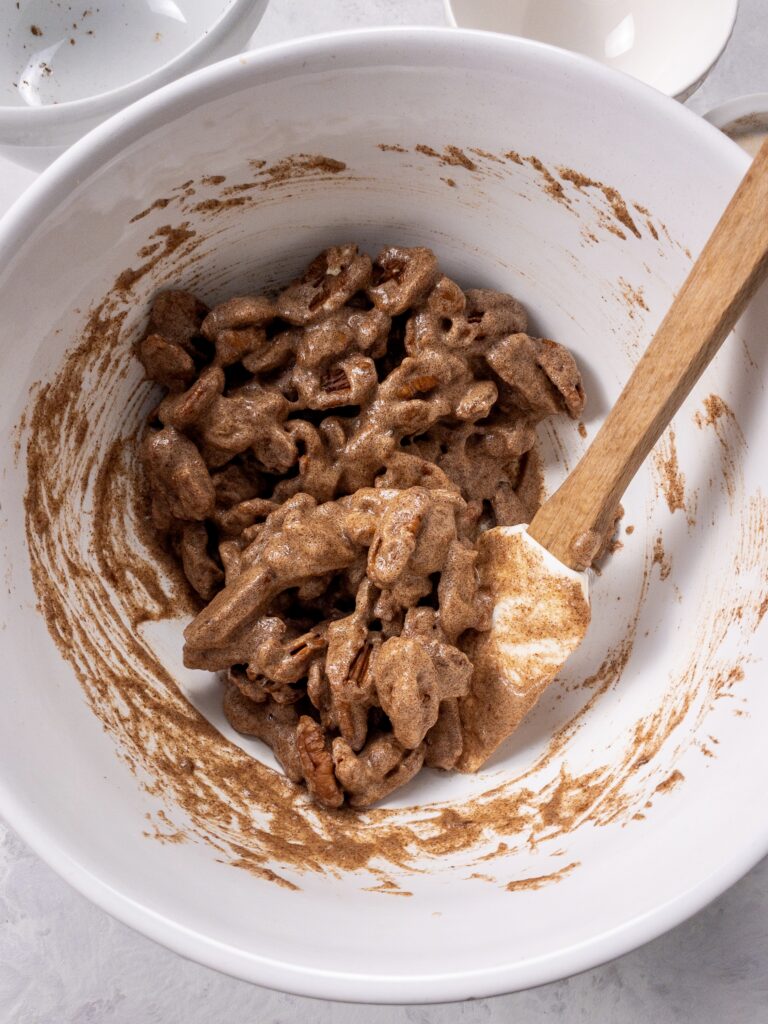 Halved pecans tossed in a light vanilla and cinnamon-spiced candy coating before being baked.