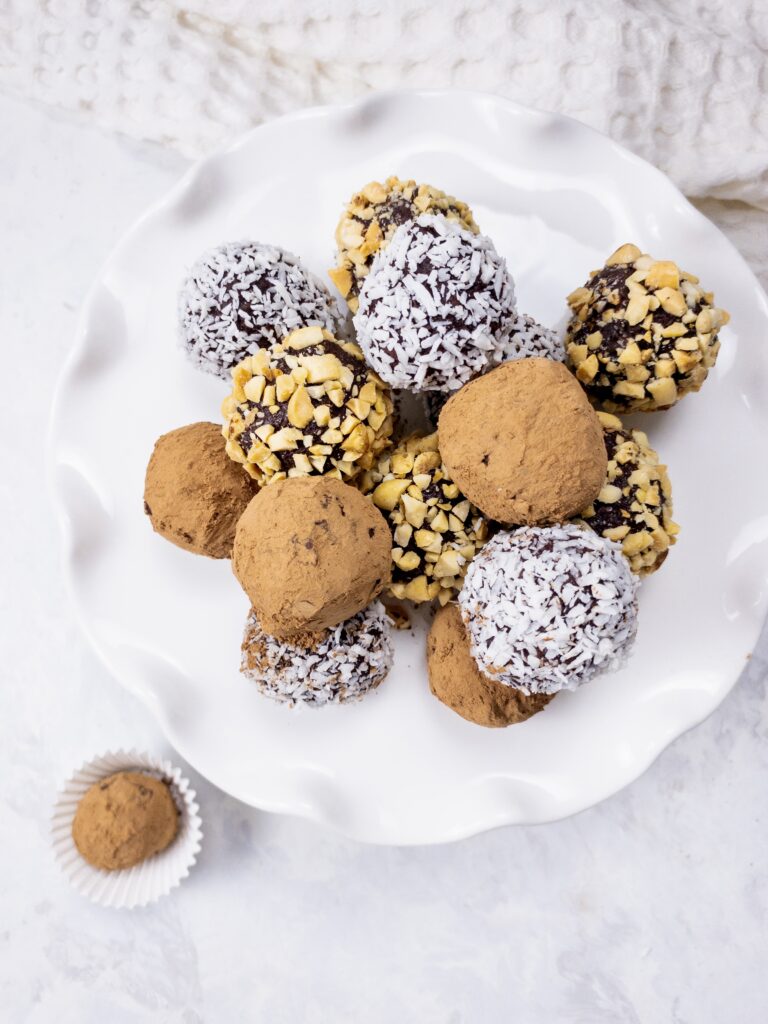 Keto Chocolate Truffles rolled in cocoa powder, shredded coconut, and crushed peanuts for an easy keto-friendly dessert.