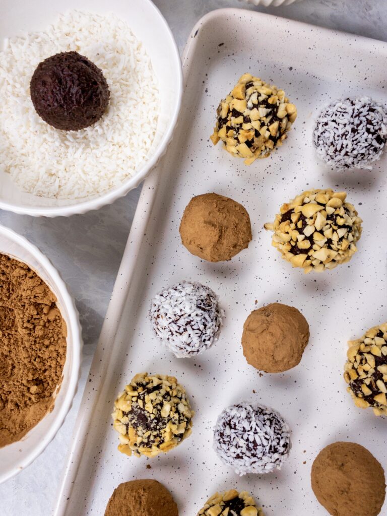 Ganache truffles coated in an assortment of shredded coconut, cocoa powder, and chopped nuts.