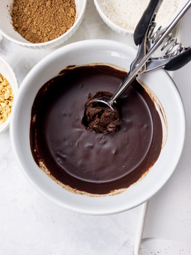 Chocolate ganache being scooped into balls to make rich, decadent Chocolate Truffles.