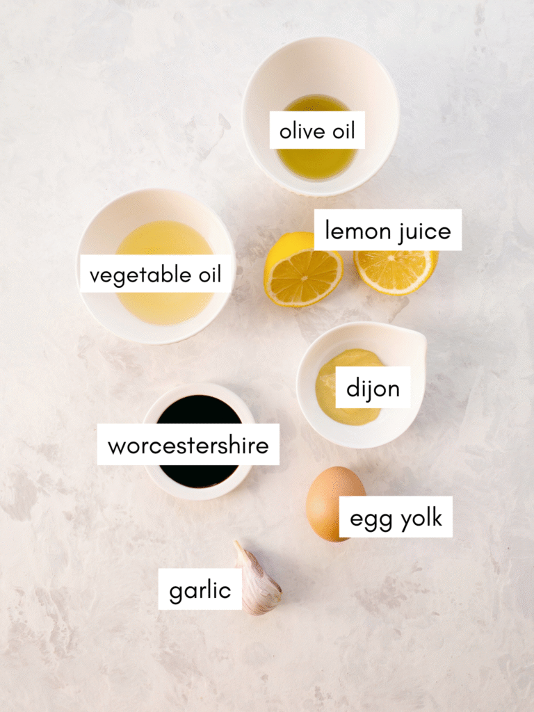 Ingredients required for homemade Caesar salad dressing: olive oil, vegetable oil, lemon juice, Dijon mustard, Worcestershire sauce, egg yolk, and garlic.
