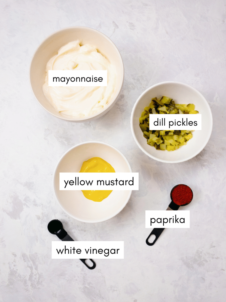 Ingredients for homemade keto-friendly burger sauce: mayonnaise, dill pickles, yellow mustard, paprika, and white vinegar.