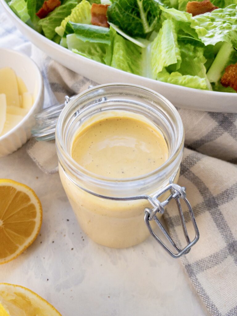 Creamy, bright, tangy Caesar dressing made from scratch the traditional way with egg yolk and oil.