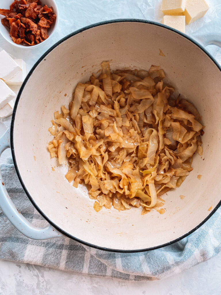 Green cabbage braised in a dutch oven.