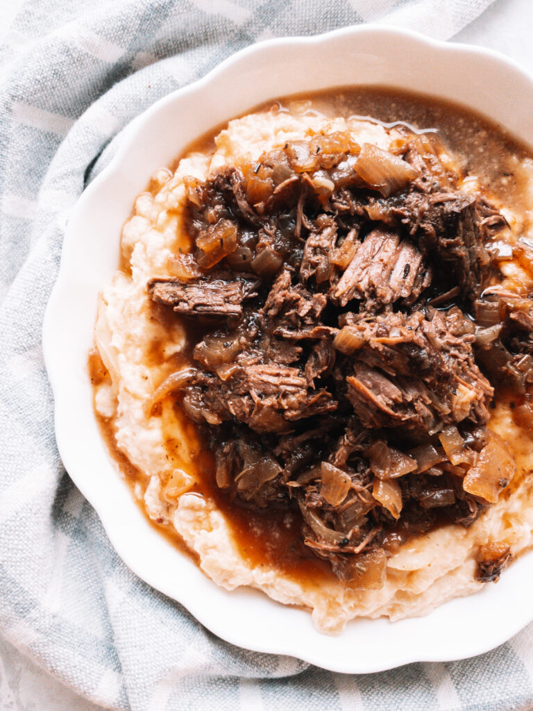 Instant Pot French Onion Pot Roast served atop creamy mashed rutabaga.